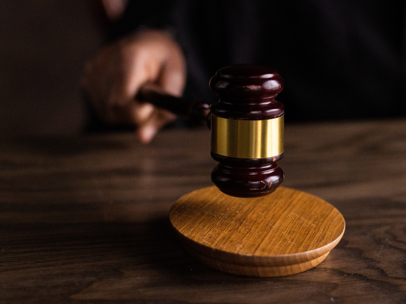 Brown wooden gavel on brown wooden table