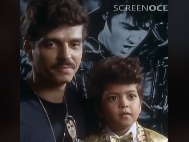 Bruno Mars at four years old sitting with his father Peter Hernandez