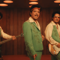 Bruno Mars wearing a green suit