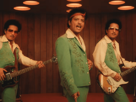 Bruno Mars wearing a green suit