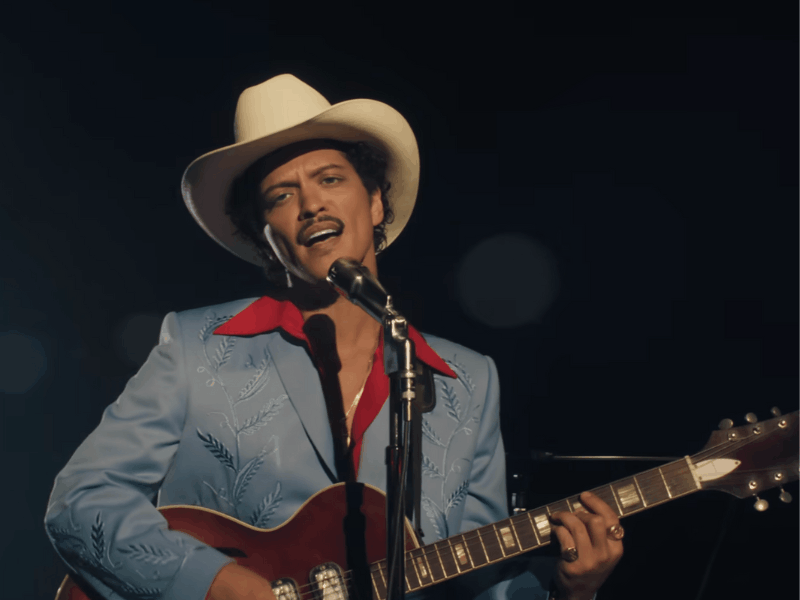 Bruno Mars playing a guitar
