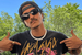 Bruno Mars wears white pearls and black sunglasses