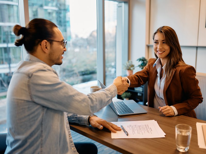 Businesswoman shaking hands with job candidate in the office