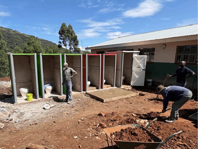 Workers busy replacing pit toilets with proper facilities
