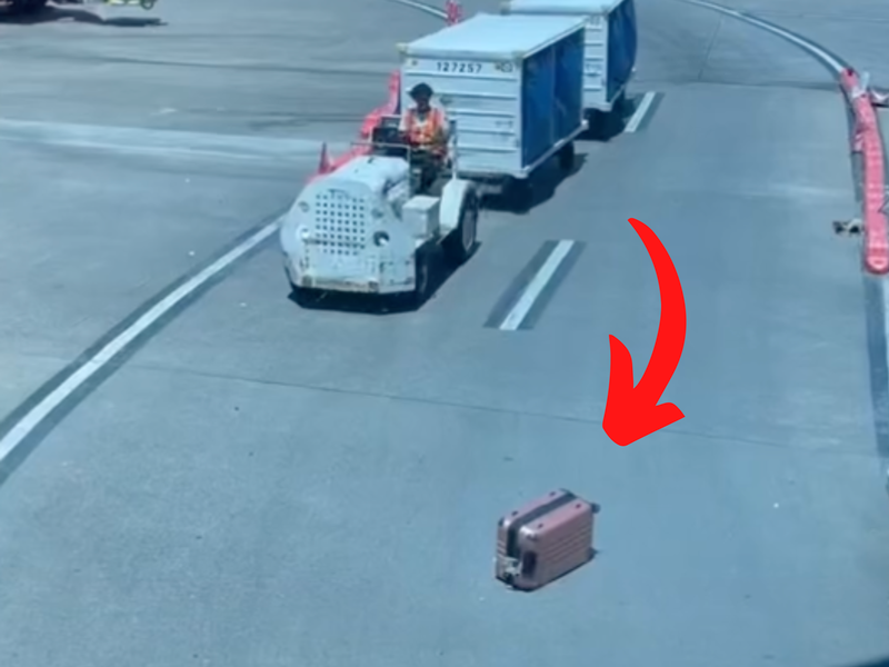 Turn around! Baggage left on the runway but will this worker pick it up?