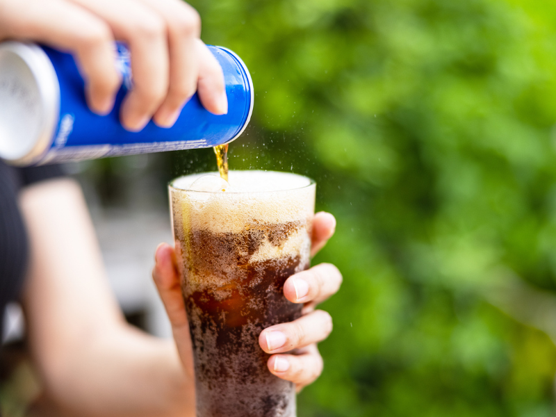 Can of soda in glass