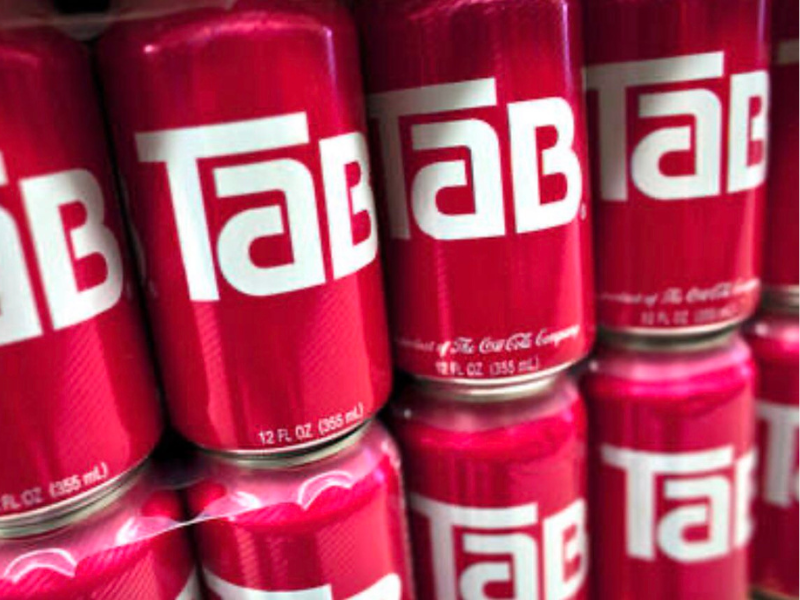Cans of Tab soda lined up on a shelf