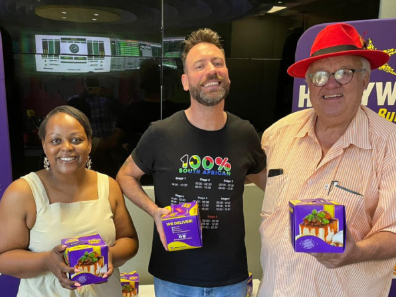 Carol Ofori, Rory Petzer and Ystar Smal stand with bunny chows