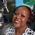 Carol Ofori at her microphone in the studio