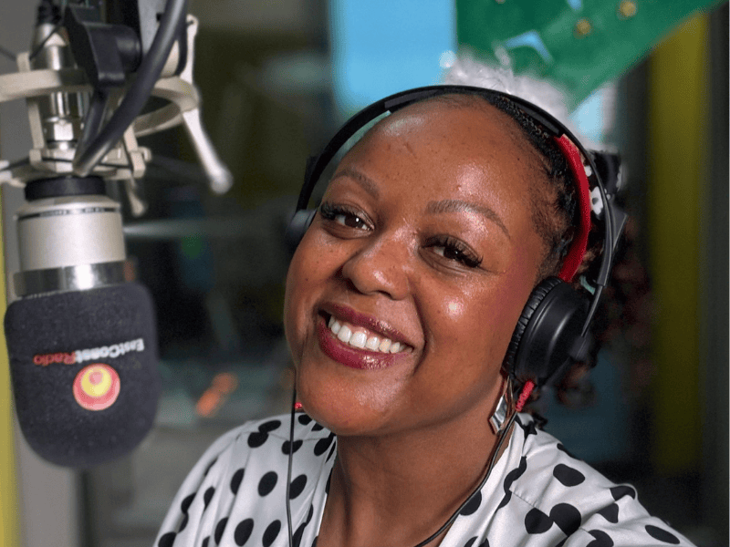 Carol Ofori at her microphone in the studio