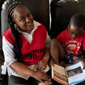 Carol Ofori helping her son with his reading homework