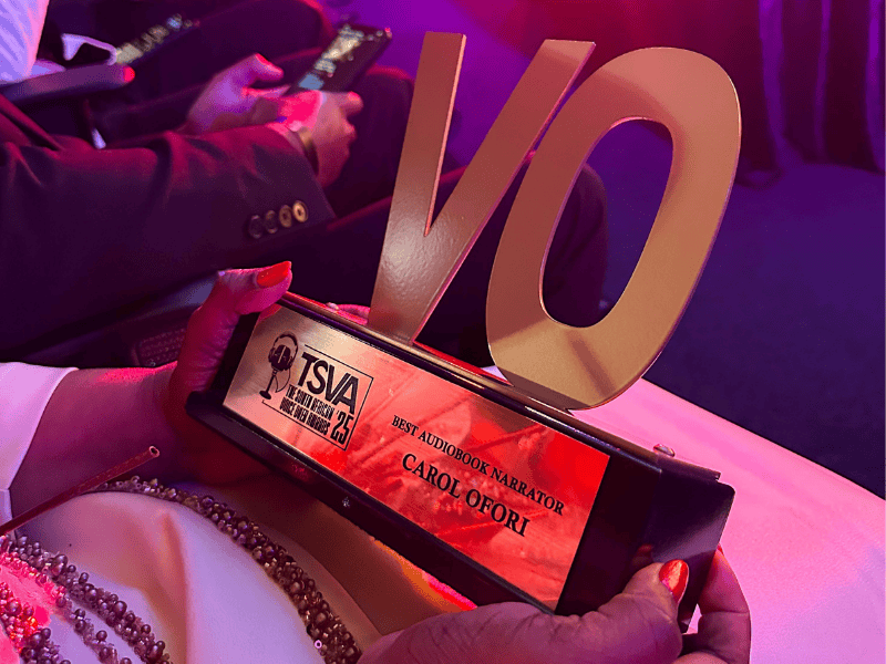 Carol Ofori holding her voice over award