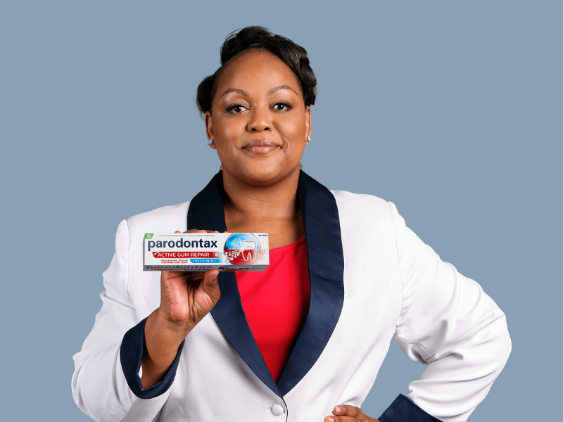 Carol Ofori holding up a toothpaste