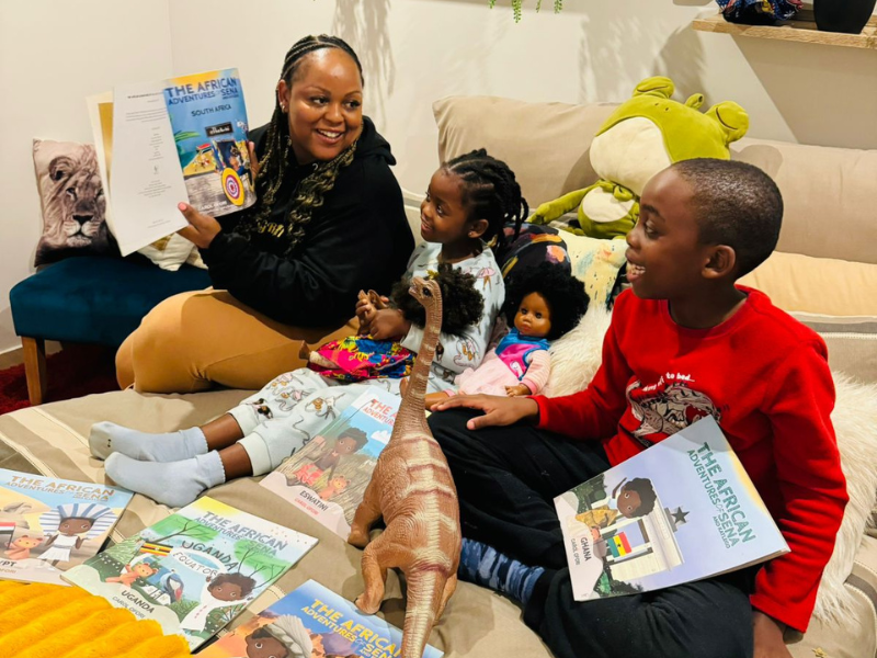 Carol Ofori reads her books to her kids in their home