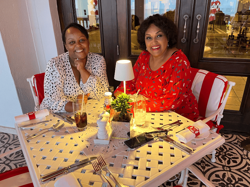 Carol Ofori sits with her mother at a restaurant