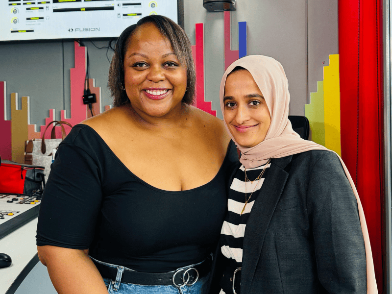 Carol Ofori standing with Raeesa Bayat inside the East Coast Radio studios