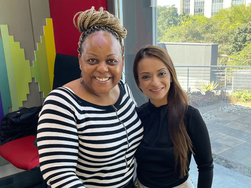Carol Ofori stands next to Payal Ramdhial inside East Coast Radio studio