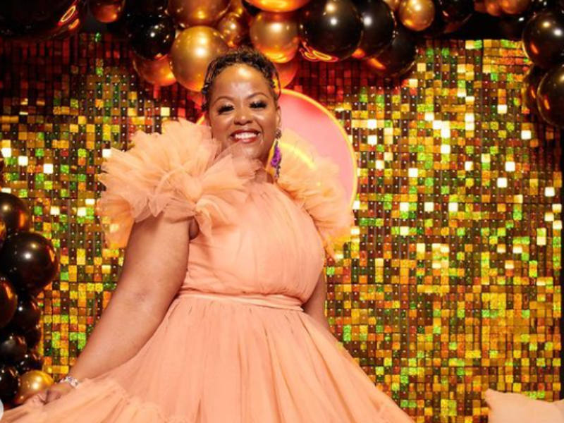 Carol Ofori wearing a pretty pink dress with sparkly background