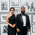 Cassper Nyovest and Pulane Phoolo posing next to a gallery wall
