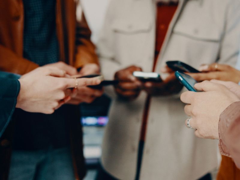 People holding cellphones in circle