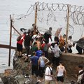 Migrants crossing from Morocco into Spain's north Africa's Ceuta enclave in July 2026