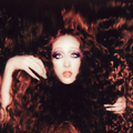 Chappell Roan with voluminous, curly auburn hair