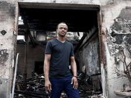Chef Ayakha Godlwana in front of burning building
