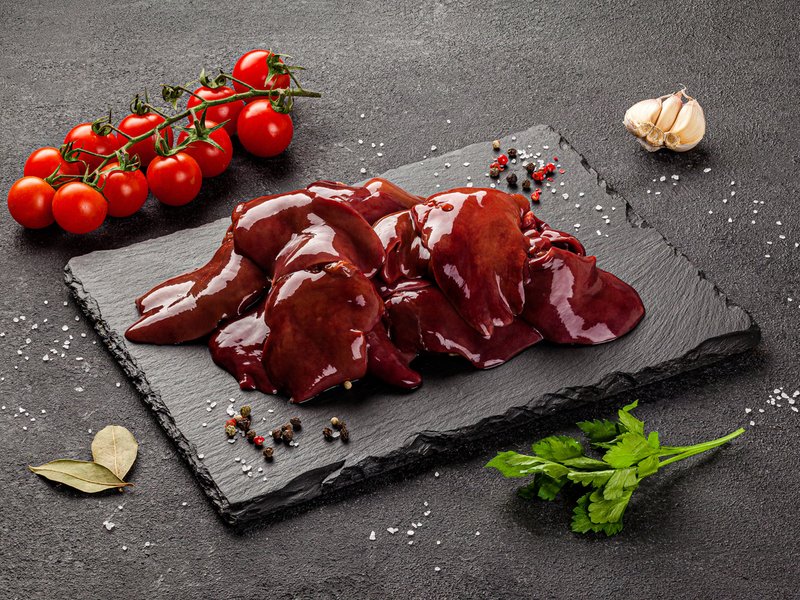 Chicken livers alongside tomatoes