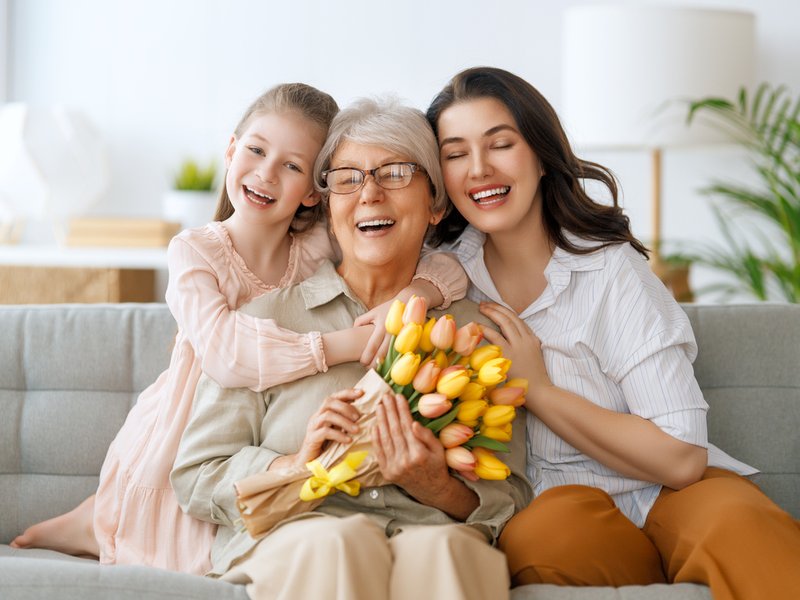 Child, mother and granny with flowers