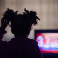 Child watching tv and holding hair