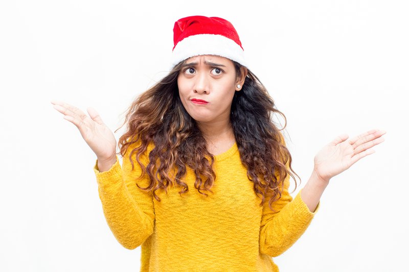 Puzzled woman wearing santa hat