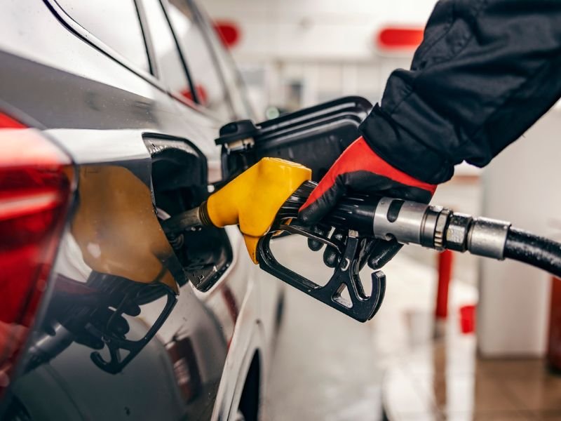 Close up of hand filling up car tank on gas station