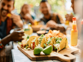 Friends eating tacos at a restaurant
