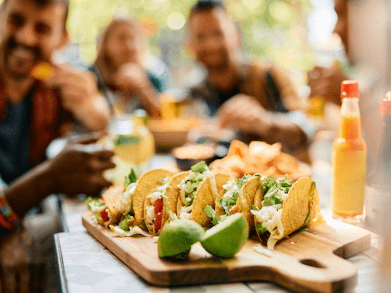 Friends eating tacos at a restaurant