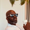 DJ Black Coffee with a drink in his hand
