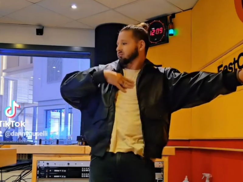 Danny Guselli dancing inside East Coast Radio studios at Suncoast Casino