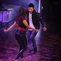 Danny Guselli dancing on stage with a woman