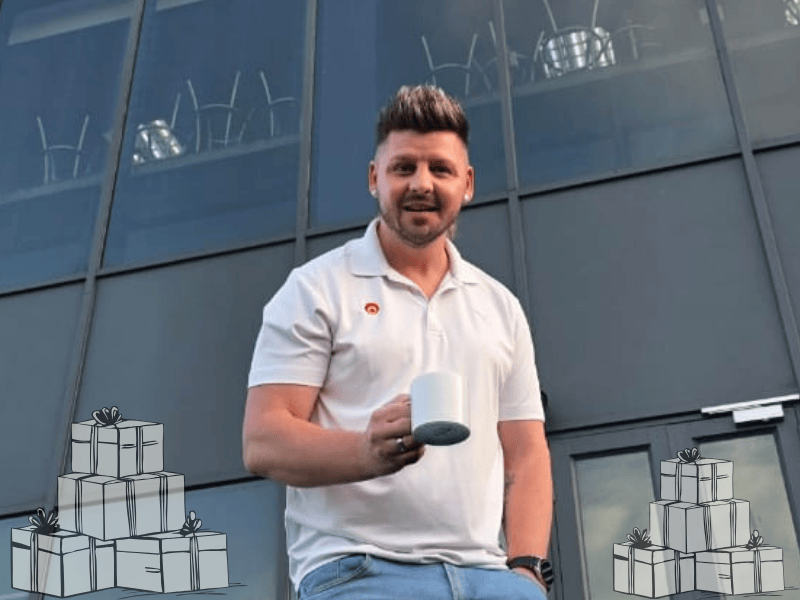Danny Guselli holds his coffee mug outside the ECR studios