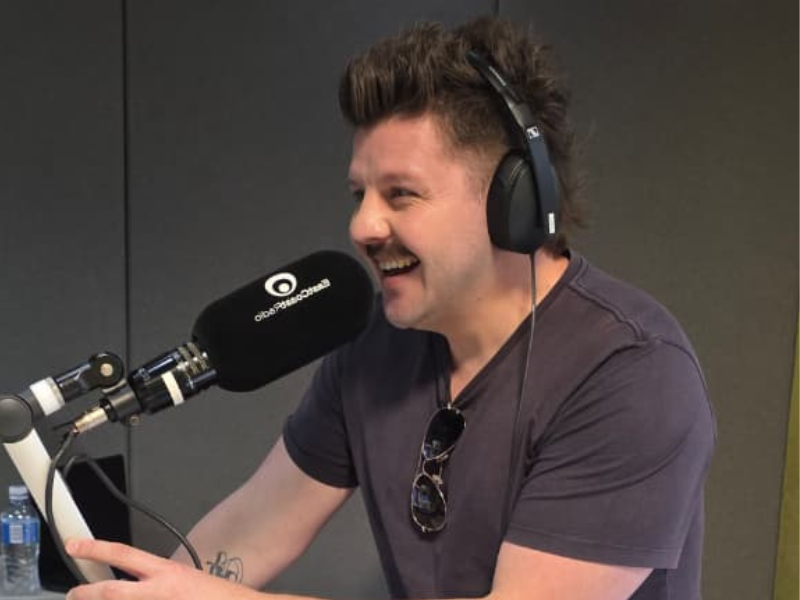 Danny Guselli speaking into the mic at the East Coast Radio studios