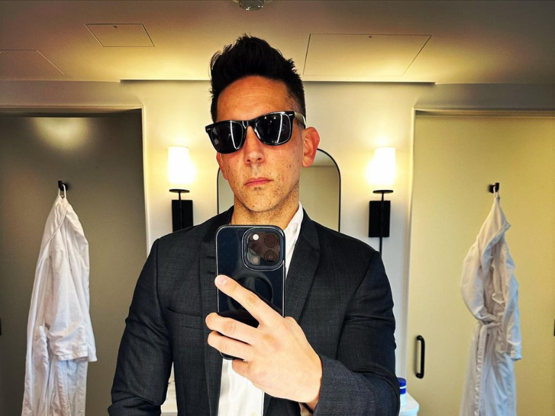 Danny K holding a black phone