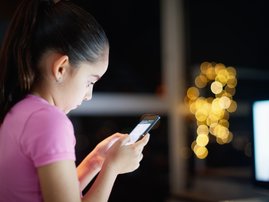 Girl writes on social network with phone
