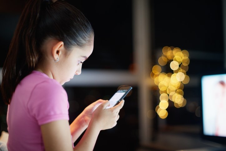 Girl writes on social network with phone