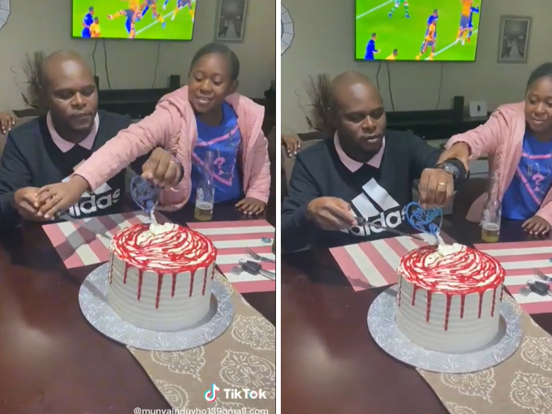 Daughter helps father cut birthday cake