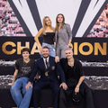 David Beckham and his family pose on a stage