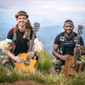 David Qadasi Jenkins and Maqhinga Radebe pose with their musical instruments in the countryside