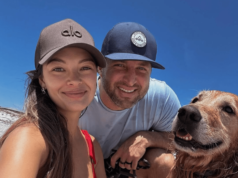 Demi-Leigh and Tim Tebow at the beach with their dog