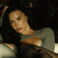 Demi Lovato posing in a moody setting