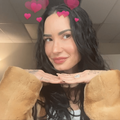 Demi Lovato poses with her chin resting on her hands