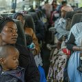 Displaced women and children from Malawi in a bus
