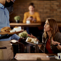 Displeased customer argues with a waiter about her food